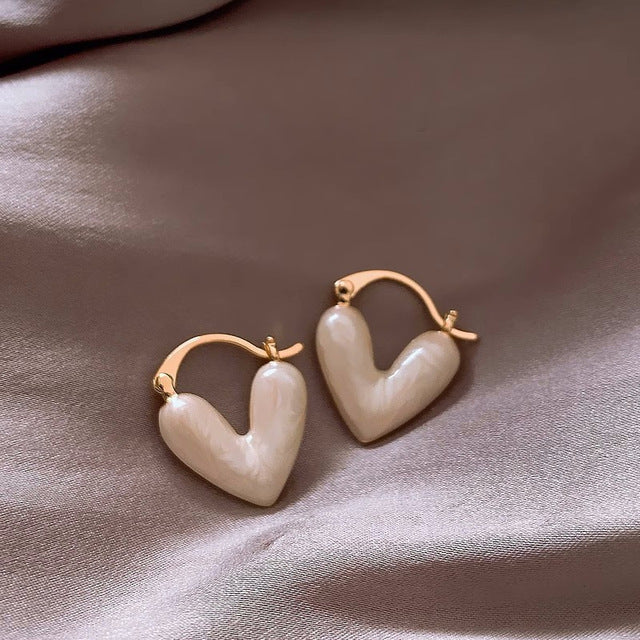 Elegant white teardrop dangle earrings for women from the Love Collection. Gold-plated fashion jewelry accessory.