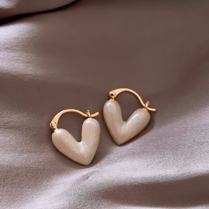 Love-inspired white teardrop dangle earrings. Elegant women's gold-plated jewelry for fashion.