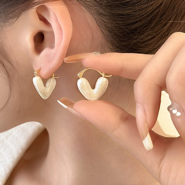 Sophisticated women's white teardrop dangle earrings. Elegant gold-plated Love Collection jewelry.