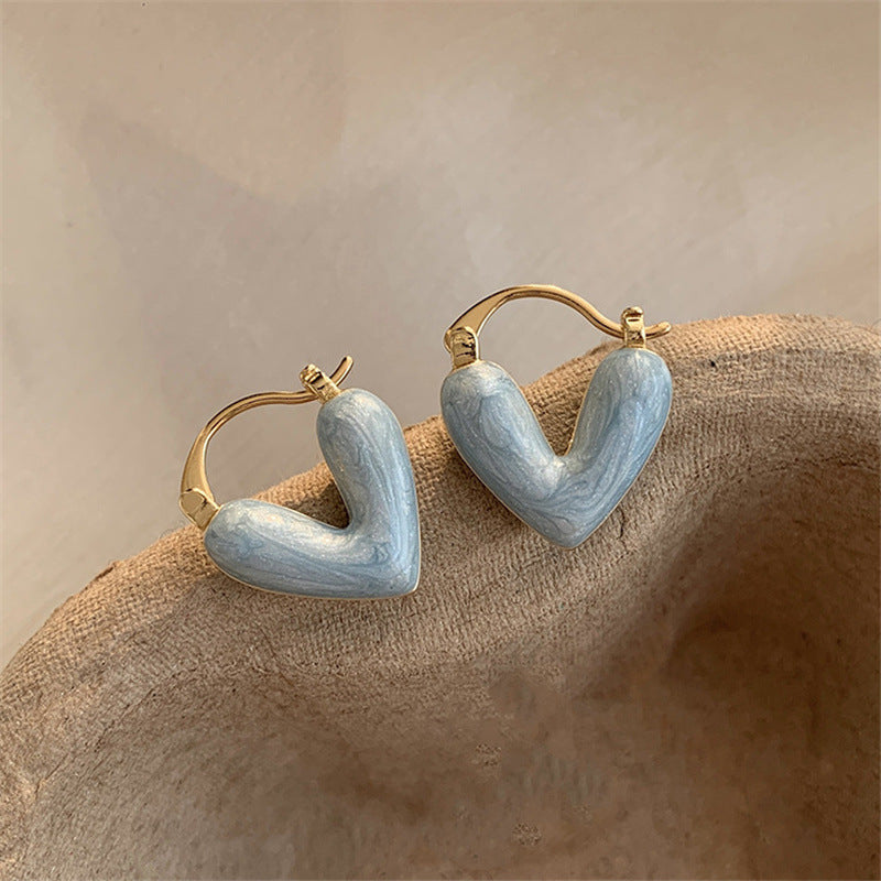 Elegant white teardrop dangle earrings for women. Versatile gold-plated love-inspired fashion jewelry.