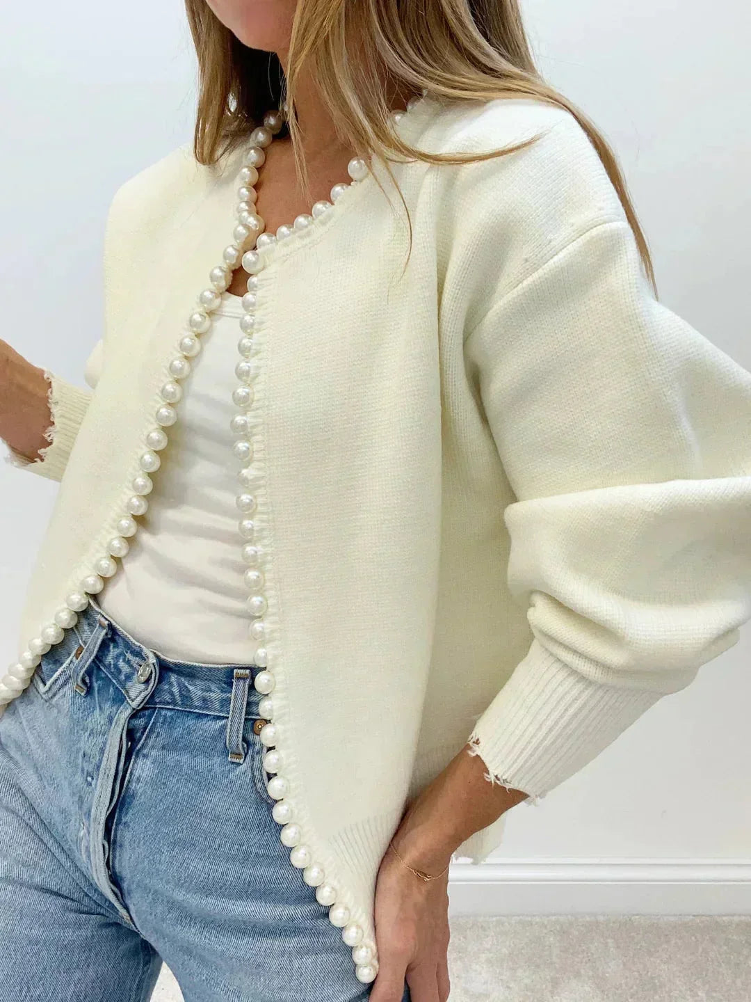 Elegant white women's pearl trim knit cardigan with round neck and long sleeves. Chic layering for sophisticated style.