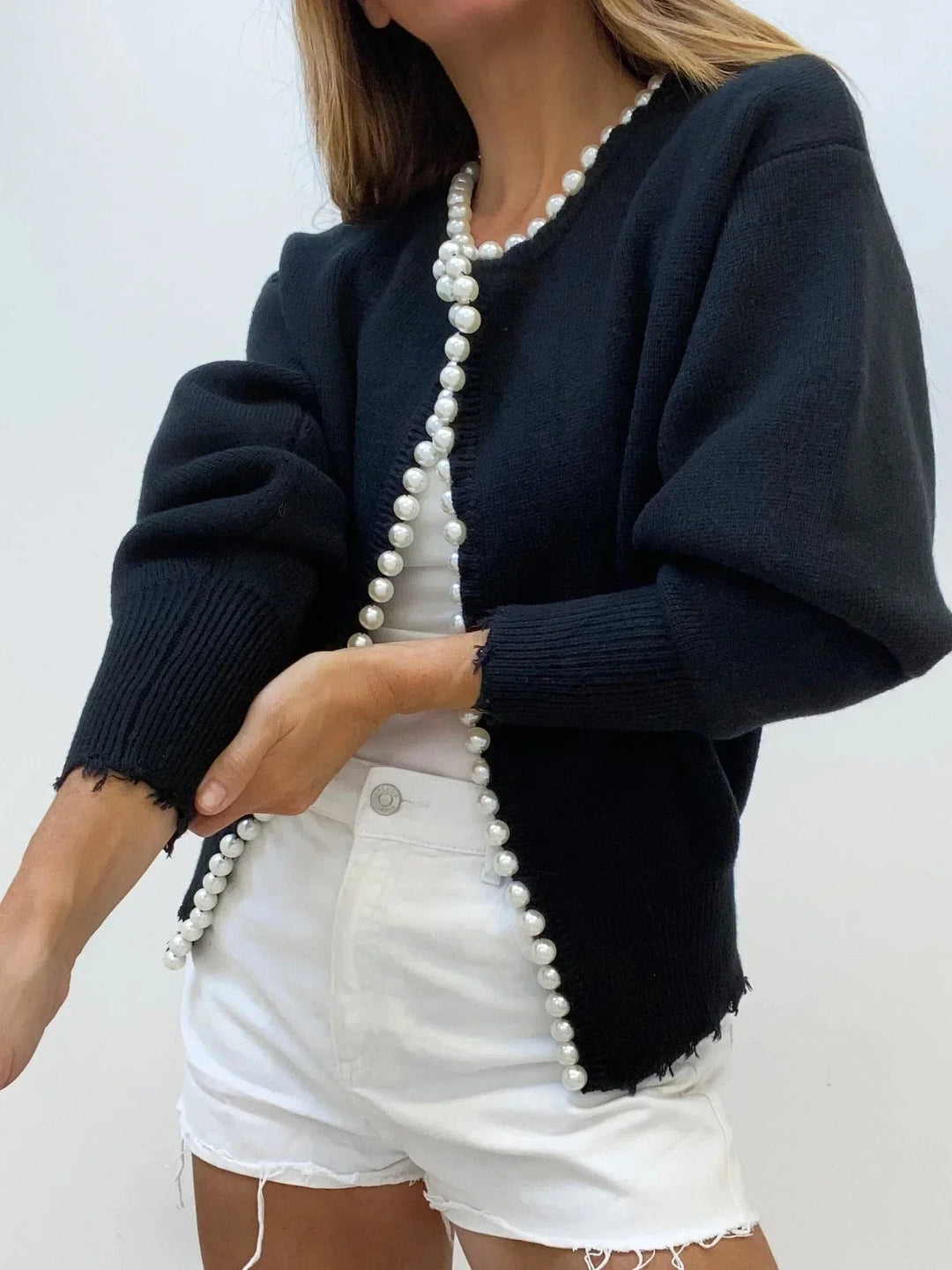 Versatile white knitwear women's cardigan with pearl trim & round neck. Ideal for work, brunch, or casual wear.