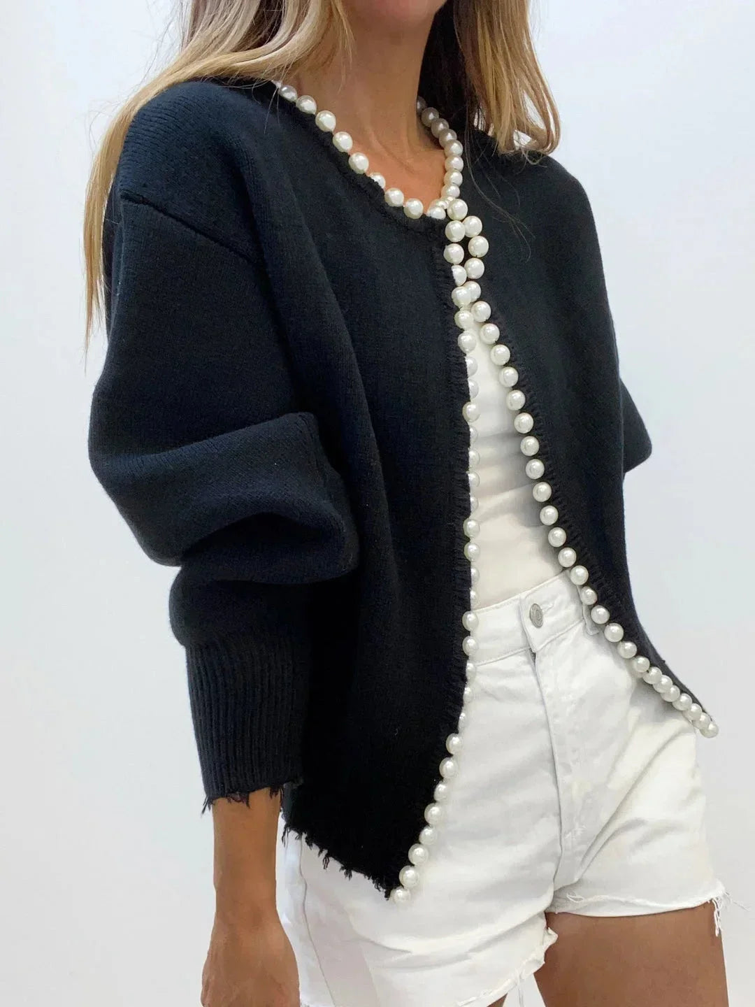 Classic women's pearl trim knit cardigan in black, featuring a flattering round neck and long sleeves.
