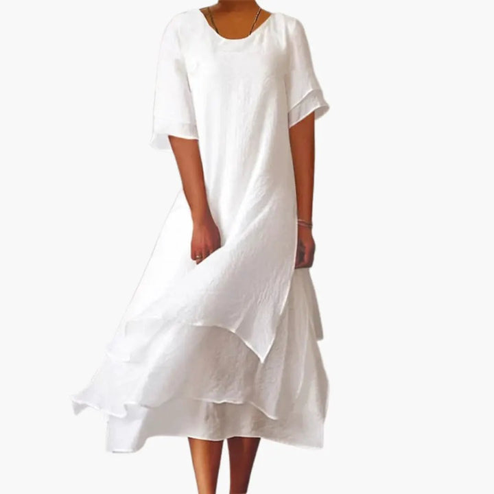 Elegant white women's sleeveless midi dress with a round neckline, perfect for casual summer wear or day-to-night styling.