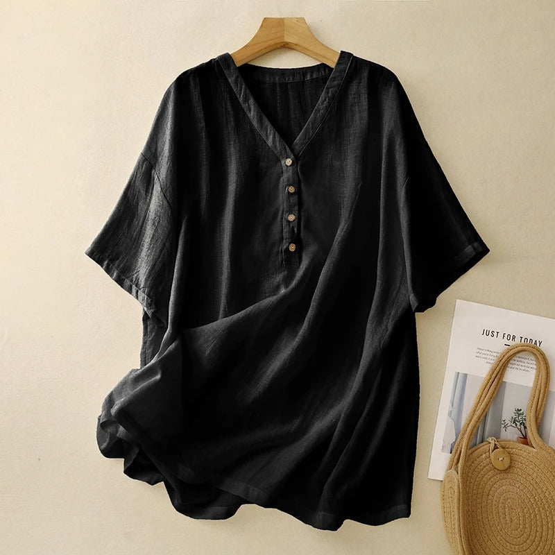 Flowing black V-neck blouse for women, featuring comfortable half sleeves & a relaxed fit, perfect for summer.