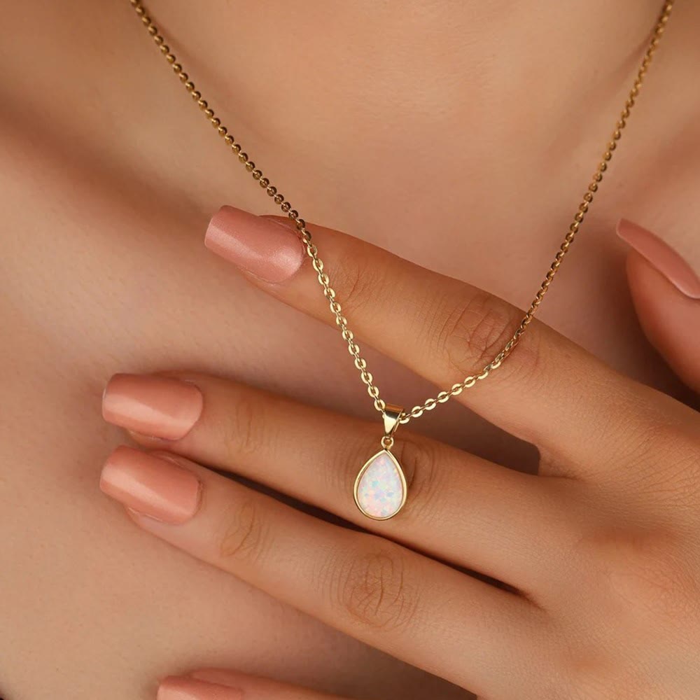 Elegant women's 18K gold necklace with a natural opal drop pendant. Fine jewelry, perfect for any occasion.