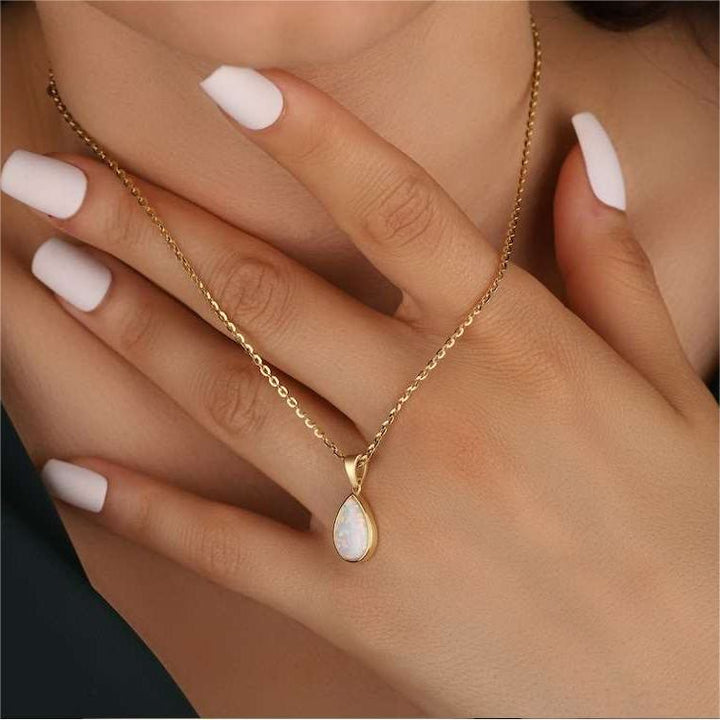 Luxurious women's 18K gold necklace with a unique natural opal drop pendant, adjustable chain.