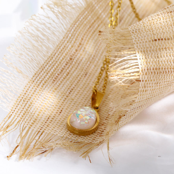 Women's fine jewelry: 18K gold drop pendant necklace featuring a shimmering natural opal gem.