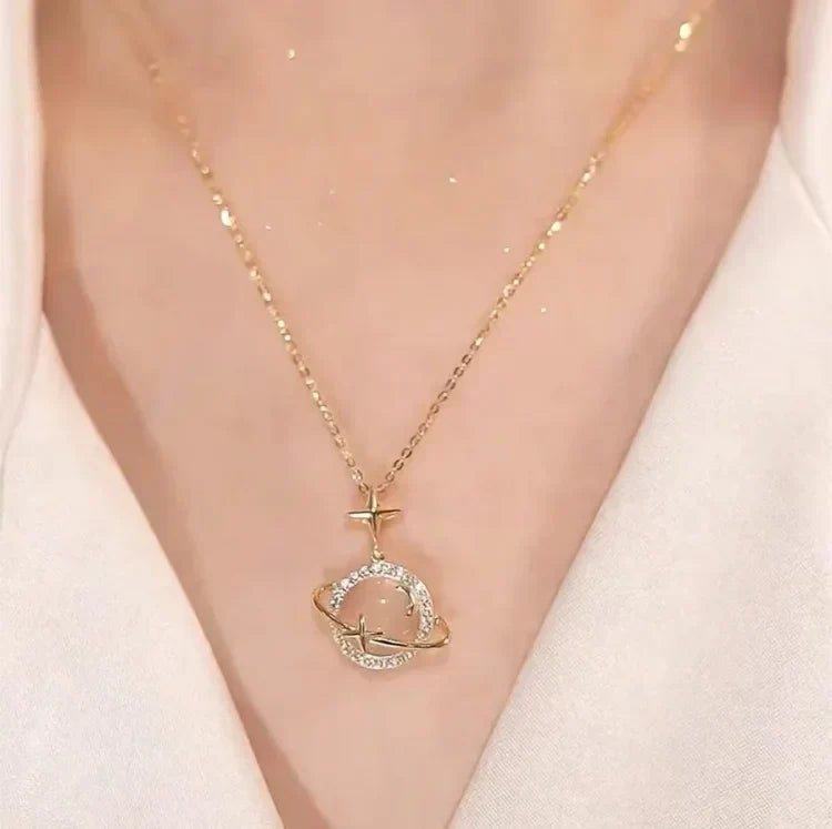 Close-up of women's 18k gold plated sterling silver celestial planet pendant necklace, elegant jewelry.