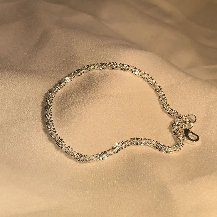 Refined women's silver liquid shine bracelet. Elegant 925 silver jewelry with a unique flowing appearance.