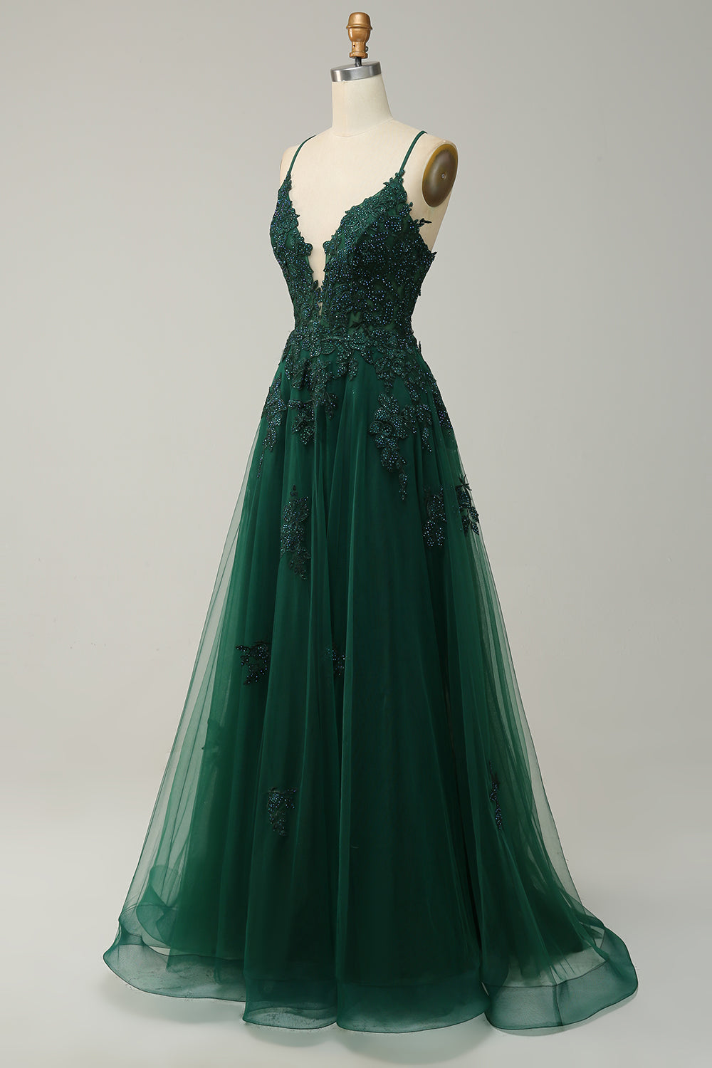 Side view of a long A-line prom dress for women, spaghetti straps, flowing silhouette. Wedding guest attire.