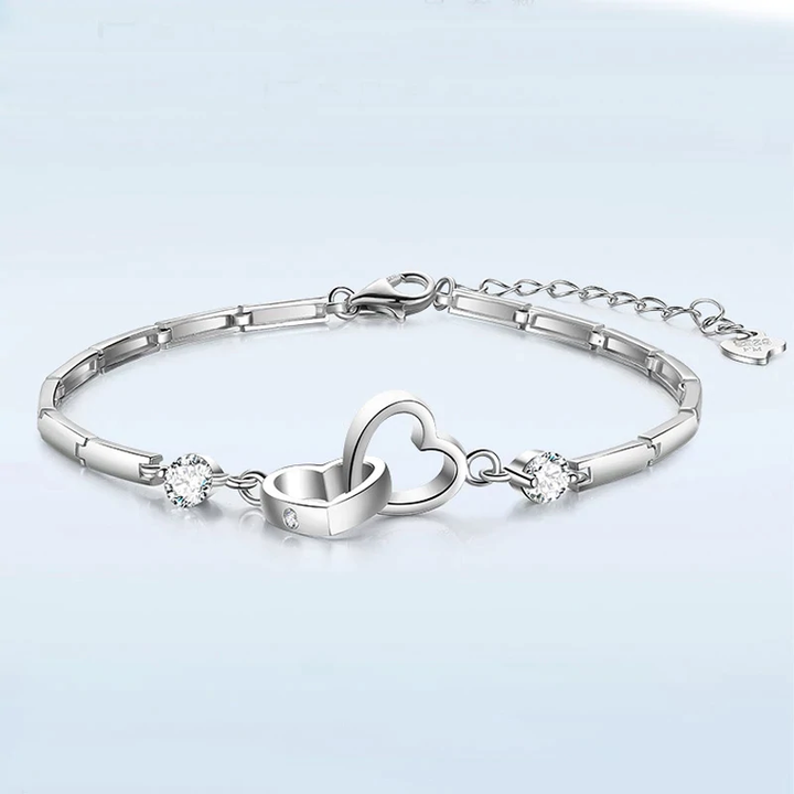 Stylish women's adjustable 925 silver double heart bracelet worn on a wrist, elegant and hypoallergenic.