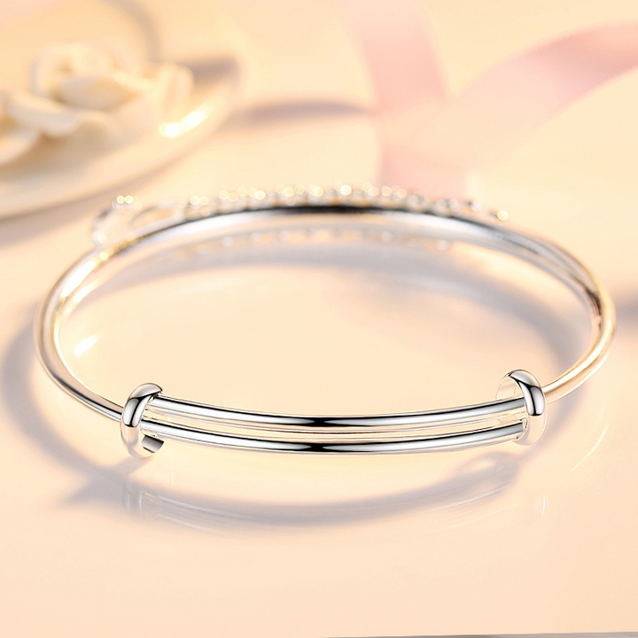 Close-up of a shimmering women's adjustable bracelet with an intricate phoenix charm, a unique and elegant jewelry accessory.