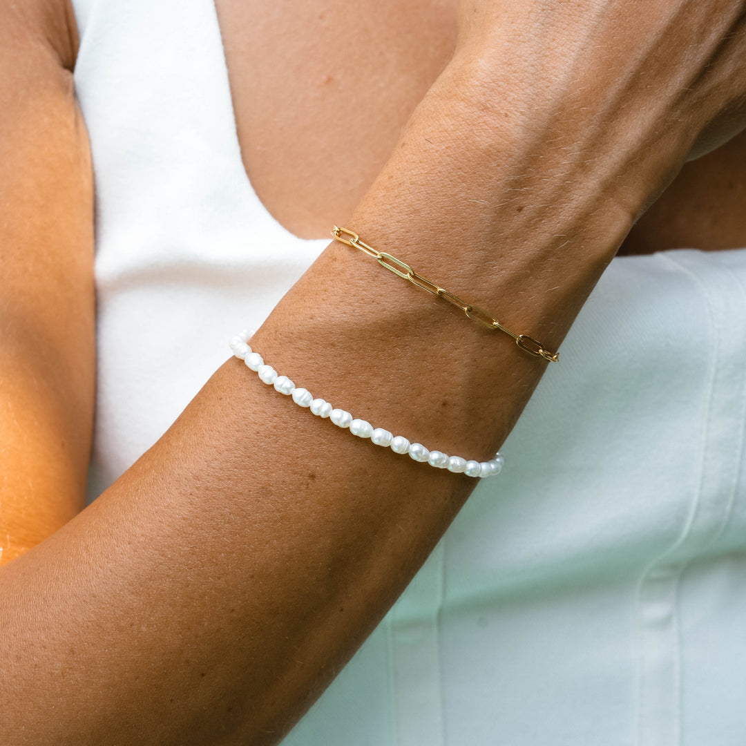 Delicate gold plated adjustable bracelet for women featuring lustrous freshwater pearls. Perfect for everyday wear.
