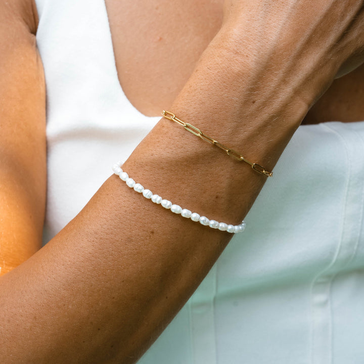 Delicate gold plated adjustable bracelet for women featuring lustrous freshwater pearls. Perfect for everyday wear.