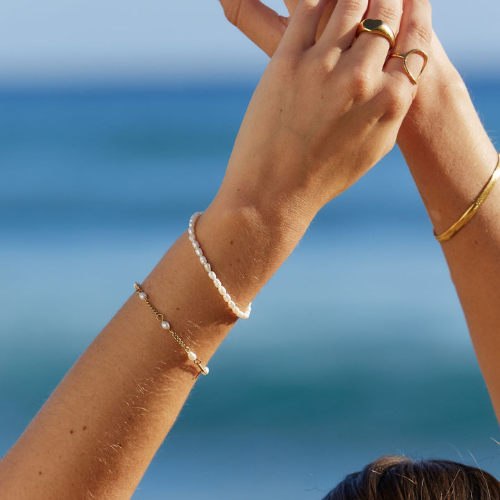 Adjustable gold plated bracelet for women, adorned with natural freshwater pearls. Delicate & elegant, a perfect gift.