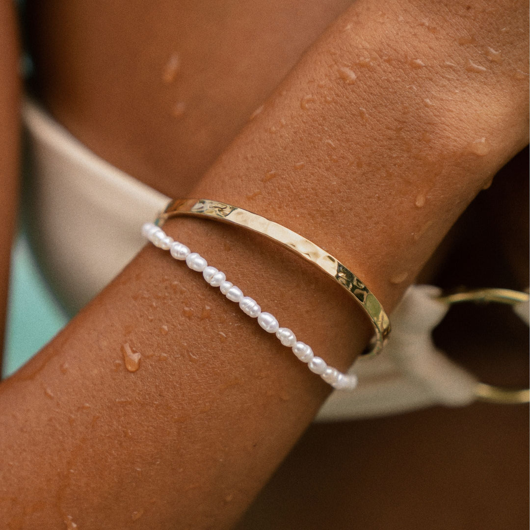 Water resistant women's pearl bracelet. Adjustable gold plated design with delicate freshwater pearls. Hypoallergenic.