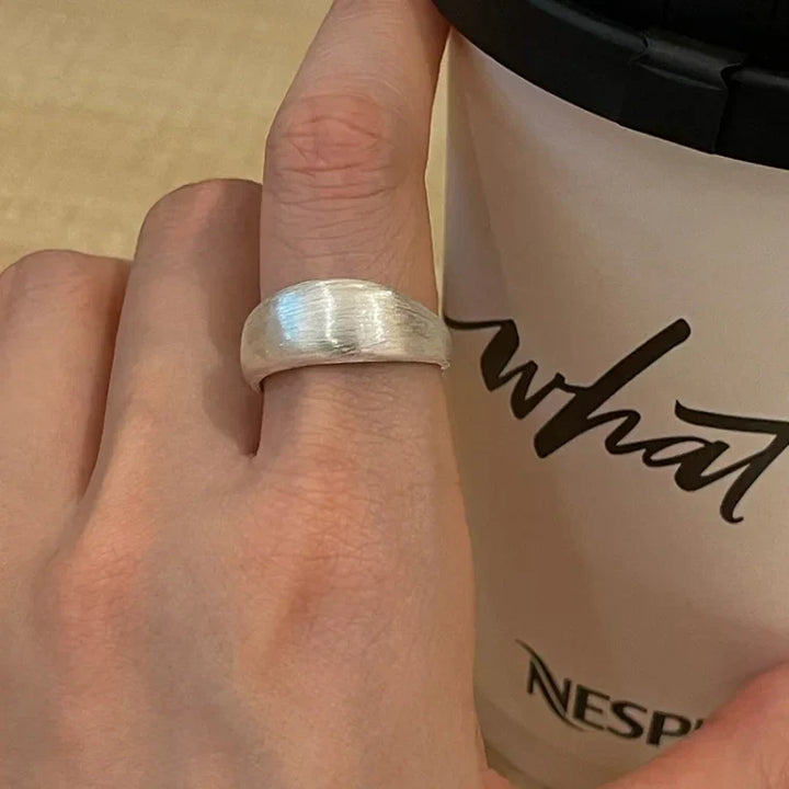 Close-up of a timeless women's pure silver adjustable dome ring, showcasing its unique brushed finish.