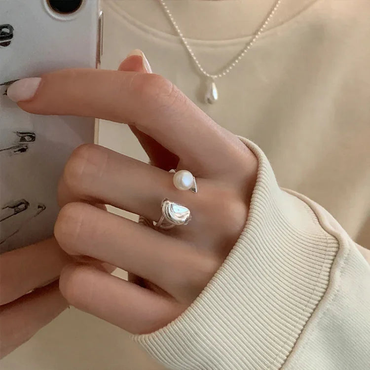 Timeless women's elegant silver ring featuring natural pearls and an adjustable band for perfect fit.