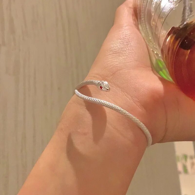Shimmering sterling silver snake bracelet for women, adjustable and featuring a polished, high-quality finish.