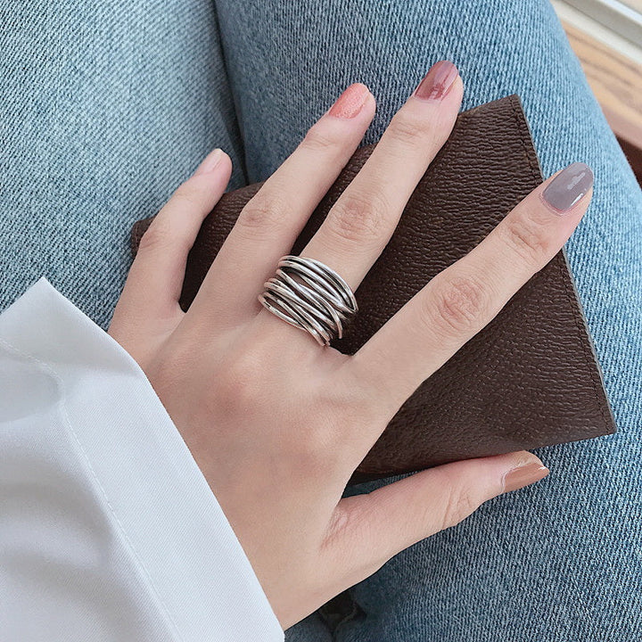 Shiny sterling silver adjustable ring for women. Modern layered design, a versatile fashion accessory.