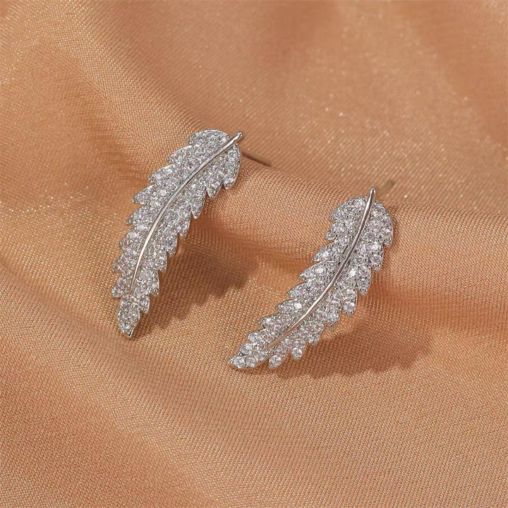 Stunning gold plated sterling silver angel wing dangle earrings for women, celestial fashion.