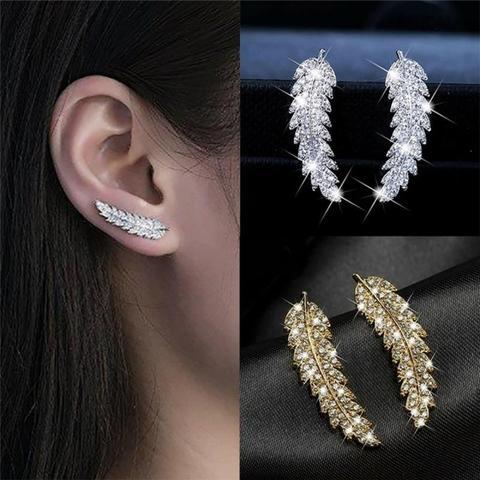 Detailed gold plated sterling silver angel wing dangle earrings. Women's celestial jewelry.