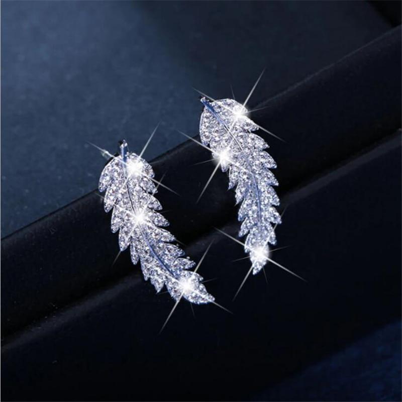 Graceful sterling silver & gold angel wing dangle earrings for women. Elegant celestial jewelry.