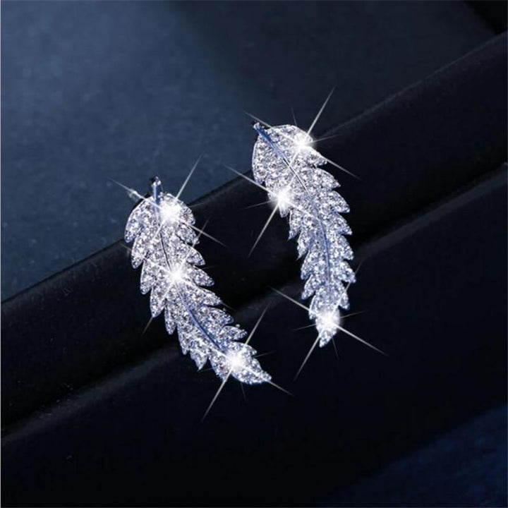 Graceful sterling silver & gold angel wing dangle earrings for women. Elegant celestial jewelry.