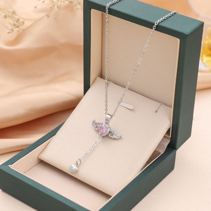 Elegant women's angel wings necklace featuring a sparkling gemstone pendant, perfect spiritual fashion jewelry.