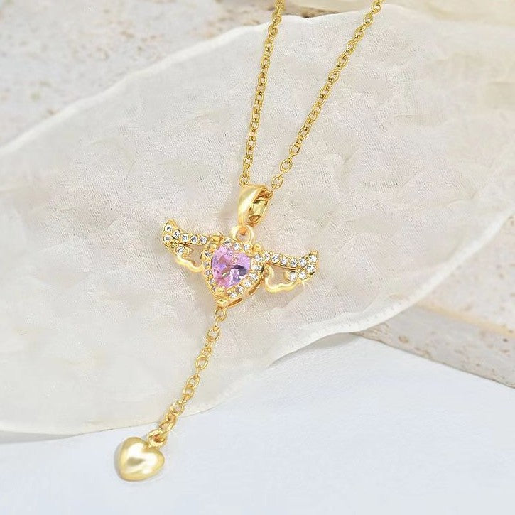 Celestial angel wings necklace with a glistening gemstone pendant, spiritual and elegant jewelry for women.