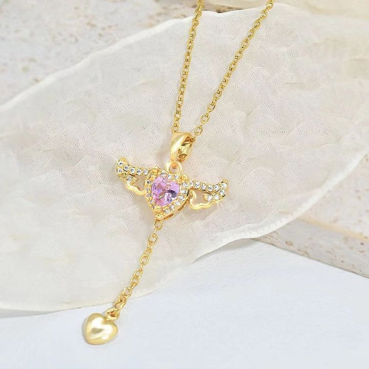 Celestial angel wings necklace with a glistening gemstone pendant, spiritual and elegant jewelry for women.