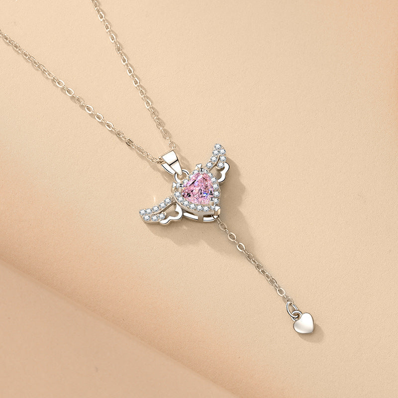 Women's angel wings pendant necklace with a brilliant gemstone, an elegant and spiritual fashion accessory.