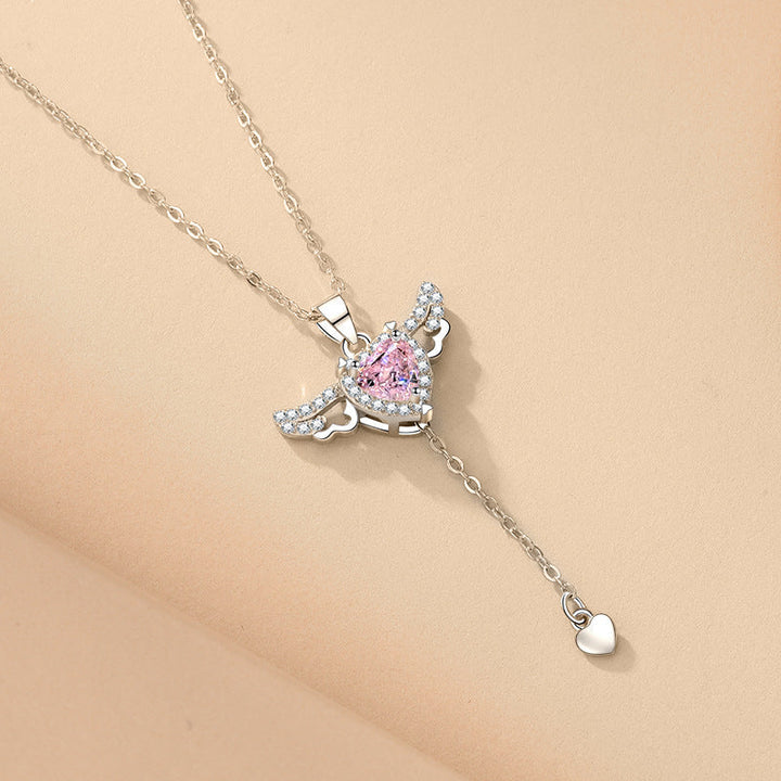 Women's angel wings pendant necklace with a brilliant gemstone, an elegant and spiritual fashion accessory.