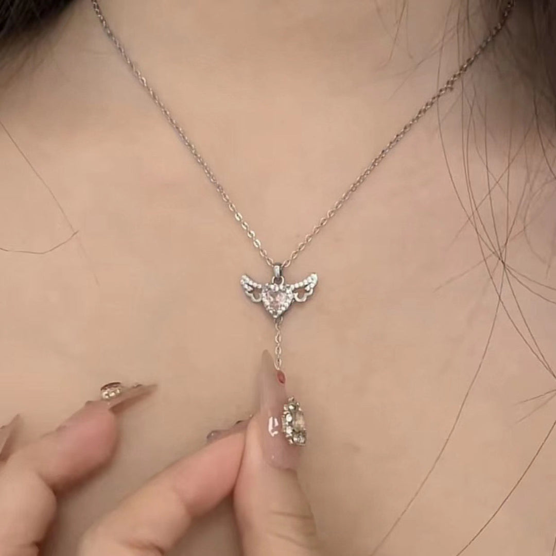Delicate angel wings necklace for women, featuring a vibrant gemstone. A celestial and spiritual jewelry gift.