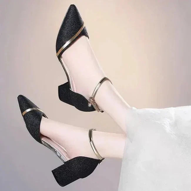 Stylish black block heel pumps featuring an elegant ankle strap and sturdy heel, ideal for formal wear.