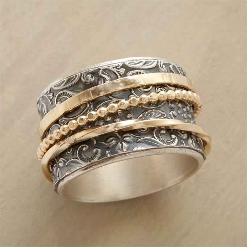 Elegant women's antique gold and silver statement ring, a vintage classic jewelry piece with intricate design.