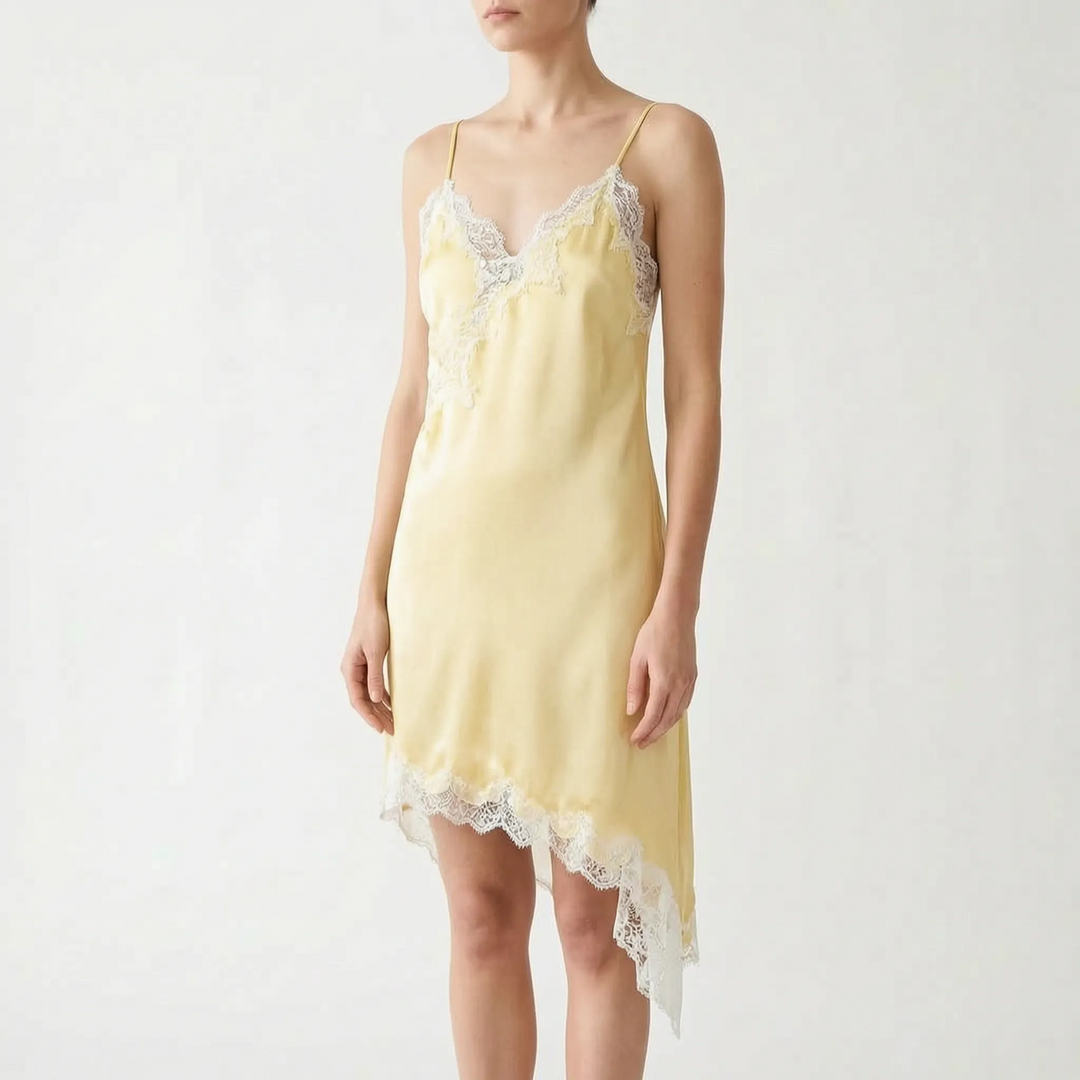 Modern women's asymmetric slip dress. Features a flattering V-neck, delicate lace, and a stylish uneven hem for evenings.
