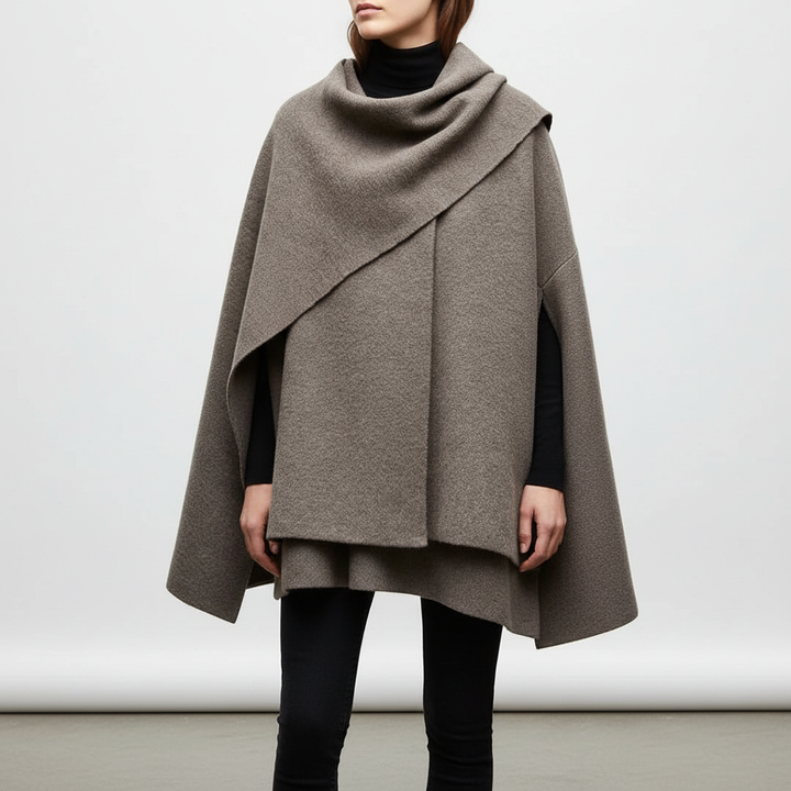 Close-up of elegant women's black asymmetrical cape jacket, showcasing unique design and fabric