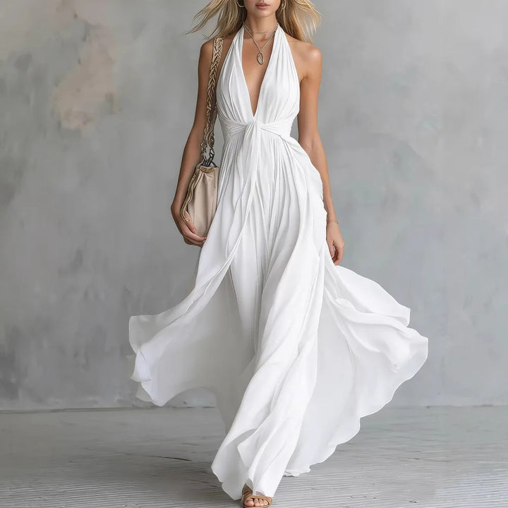 Stunning women's backless halter formal maxi dress with side slit & pleated detail for elegant occasions.