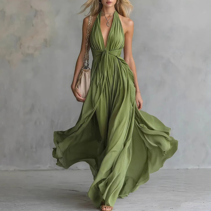 Chic women's backless halter maxi dress. Pleated design & side slit make this an elegant evening or party gown.