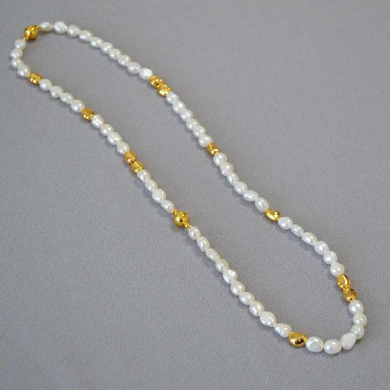UniqueGlow baroque pearl necklace, a handmade women's fashion accessory with elegant geometric accents and a radiant glow.