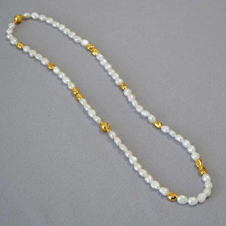 UniqueGlow baroque pearl necklace, a handmade women's fashion accessory with elegant geometric accents and a radiant glow.