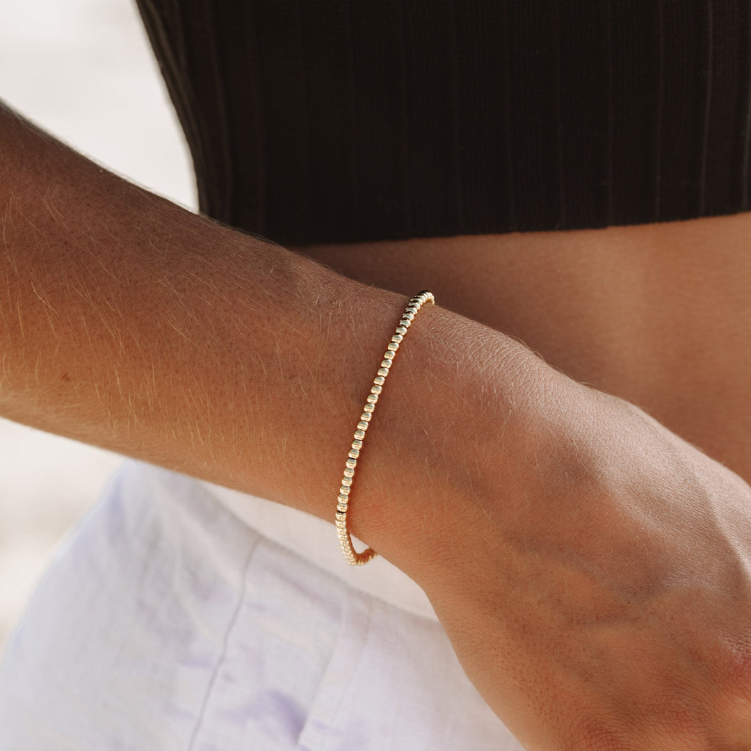 Everyday wear women's gold beaded bracelet. Elegant, stackable, and water resistant jewelry.