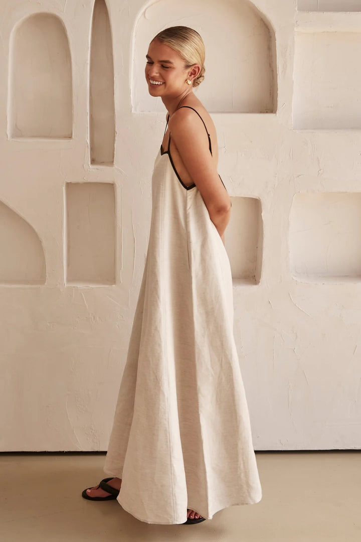 Lightweight, sleeveless beige midi summer dress for women. Elegant, flowy fabric ensures breathable comfort & style.