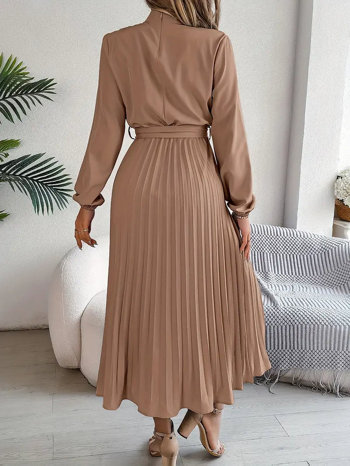 Elegant women's occasion dress: long-sleeve midi style with pleats and a defining belt.