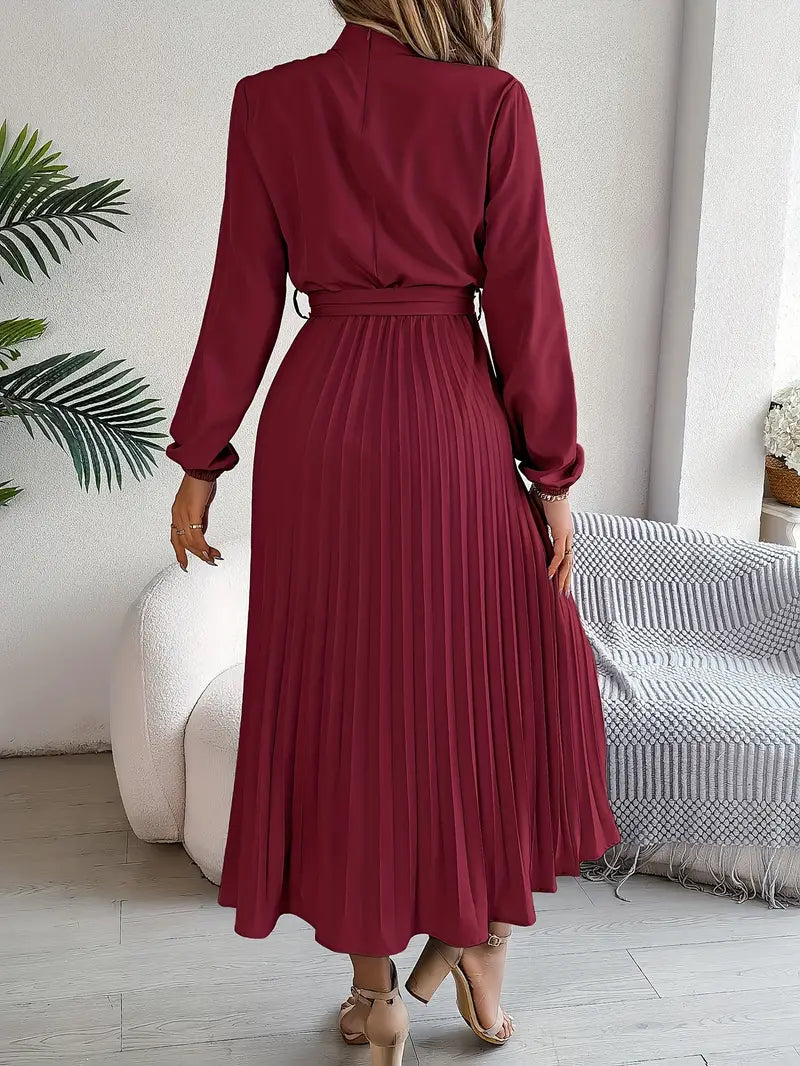 Full-length view of an elegant women's belted pleated midi dress, showcasing effortless style.