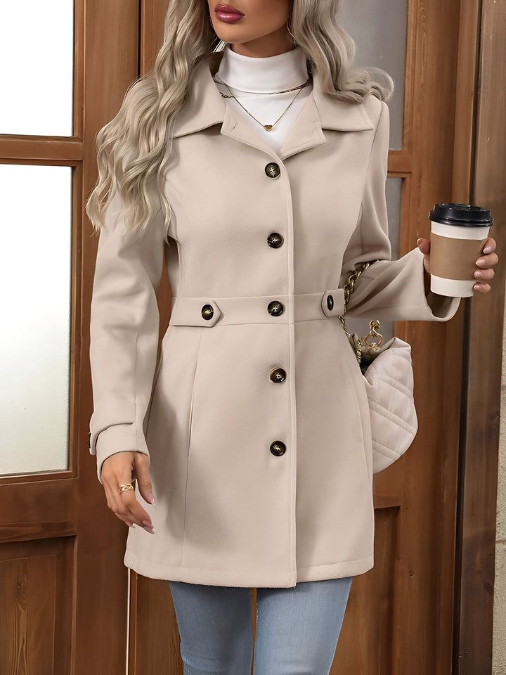 Side view of a women's sophisticated belted trench coat, highlighting its classic silhouette.