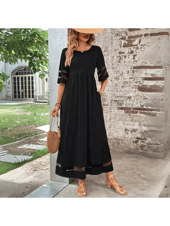 Elegant women's black A-line midi dress with tummy coverage for a flattering, comfortable fit. Perfect for any occasion.