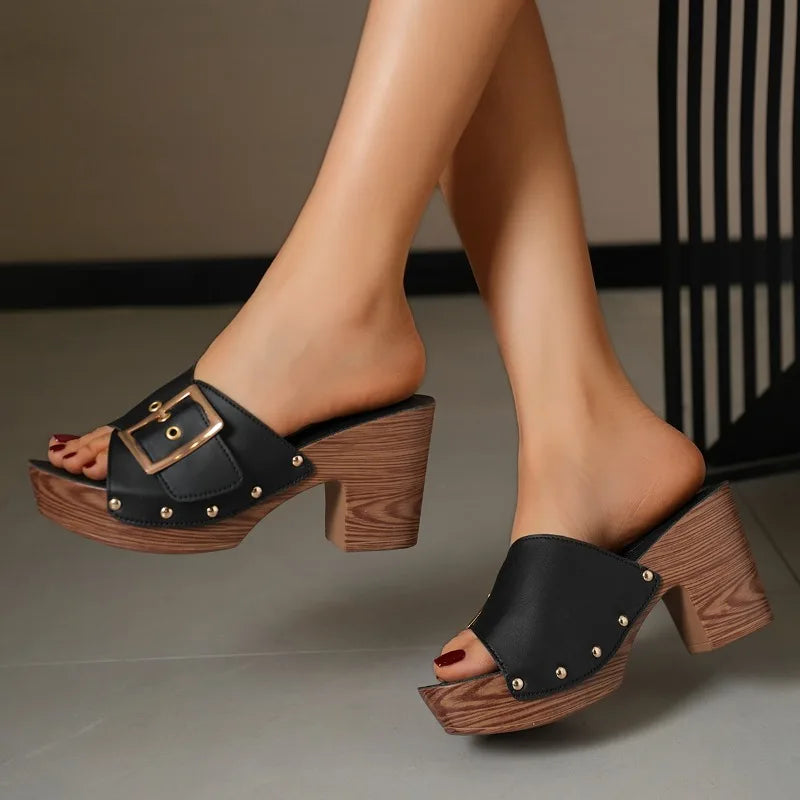 Women's contemporary block heel slides, featuring a prominent buckle and sturdy heel.